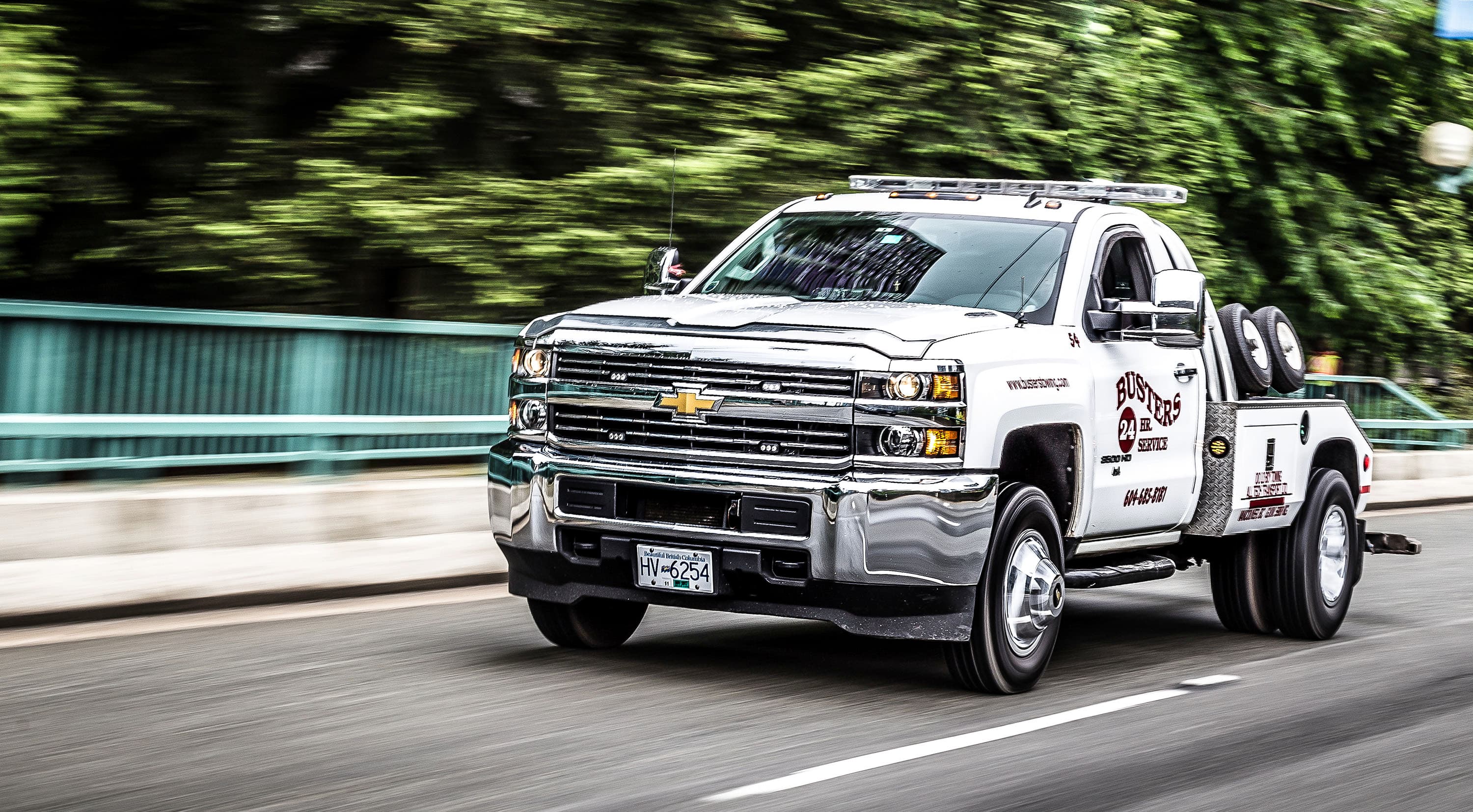 Busters Towing flatbed unit recovering a vehicle in Vancouver